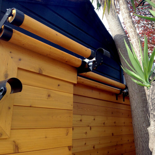 Matching custom wood fence rollers along the top of entire fence line to discourage animals