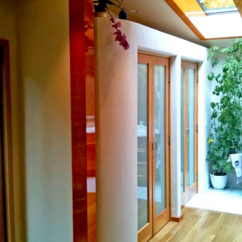 Interior view of French doors, skylight, and wood floors